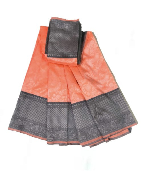 A folded jacquard silk saree in orange and ash grey combination with a blouse piece displayed alongside.